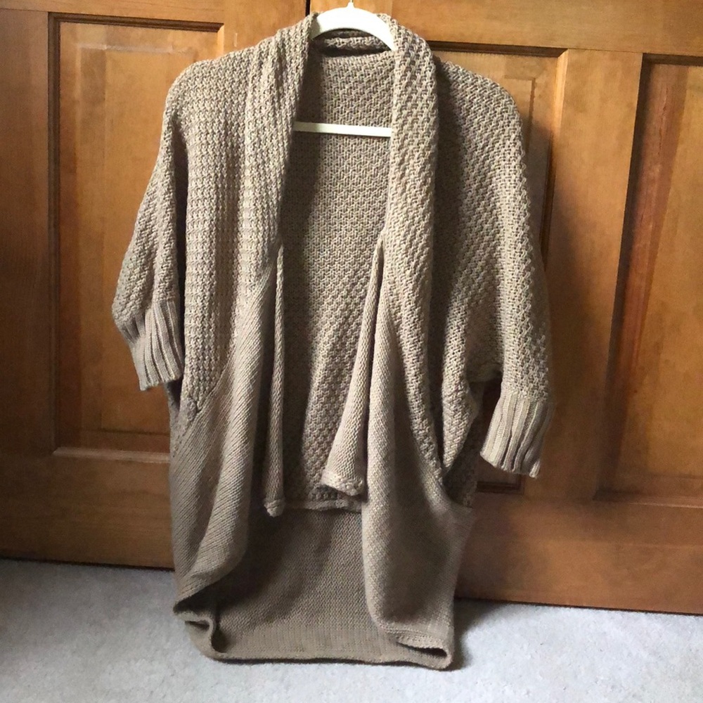 Nude color knit cardigan.
